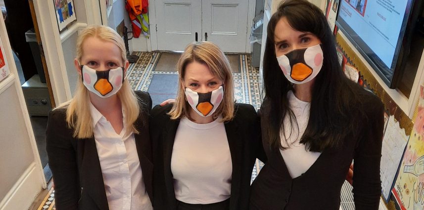 3 ladies with penguin masks on
