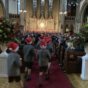 children with santa hats in a church