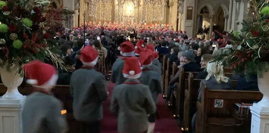children with santa hats in a church